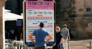 People check the FrancoFolies festival poster in La Rochelle, France.