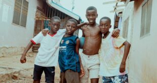 Happy group of boys enjoying friendship on a street in Accra, Ghana.