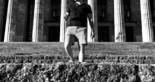 Black and white street portrait of a man at the University of Buenos Aires Law School.
