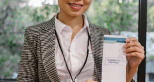 Confident businesswoman presenting a conference program indoors.